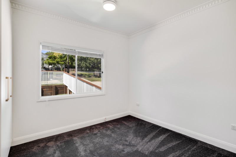 Bedroom with new carpet and windows