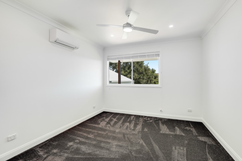 Bedroom with ceiling fan and air-conditioning