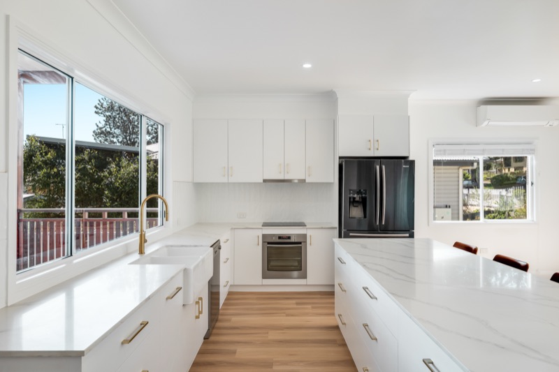 Kitchen with stone benchtops and brass tapware