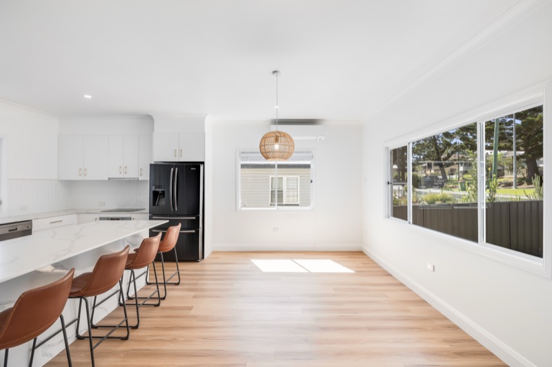 Kitchen island with bar stools looking to the living area
