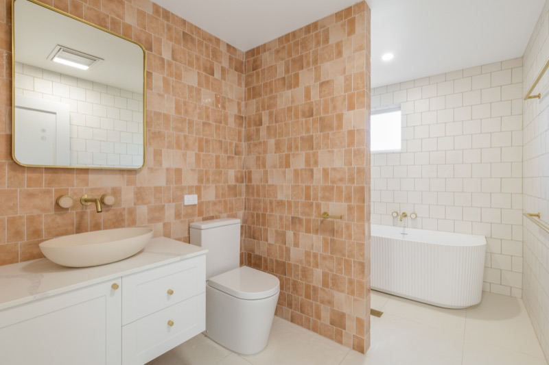 Bathroom with freestanding bath and terracotta tiles