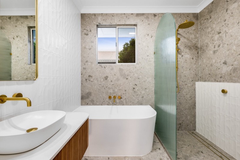 Bathroom with freestanding bath and terrazzo-look tiles