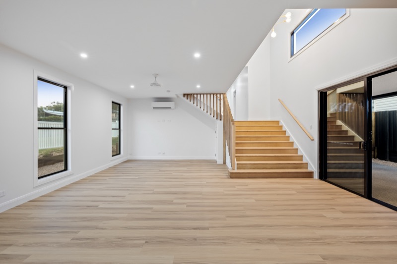 Living area and timber staircase to the upper floor