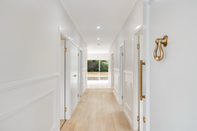 Hallway with original doors and brass hardware