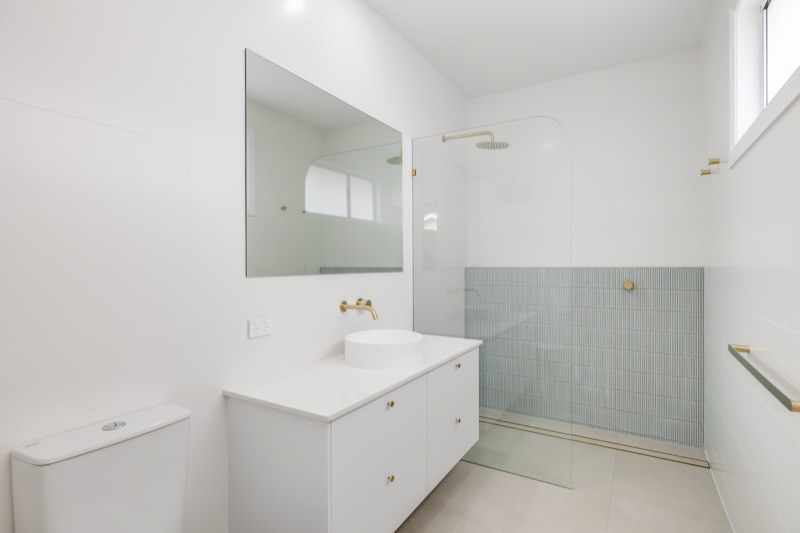 Ensuite with frameless shower and sage tiles
