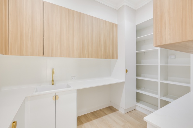 Walk-in pantry with timber shelving