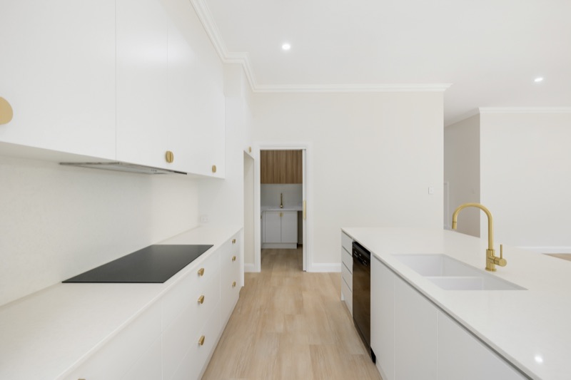 Galley kitchen with brass tapware