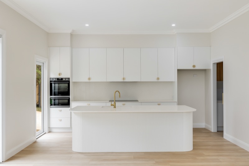 Kitchen with island bench and white joinery